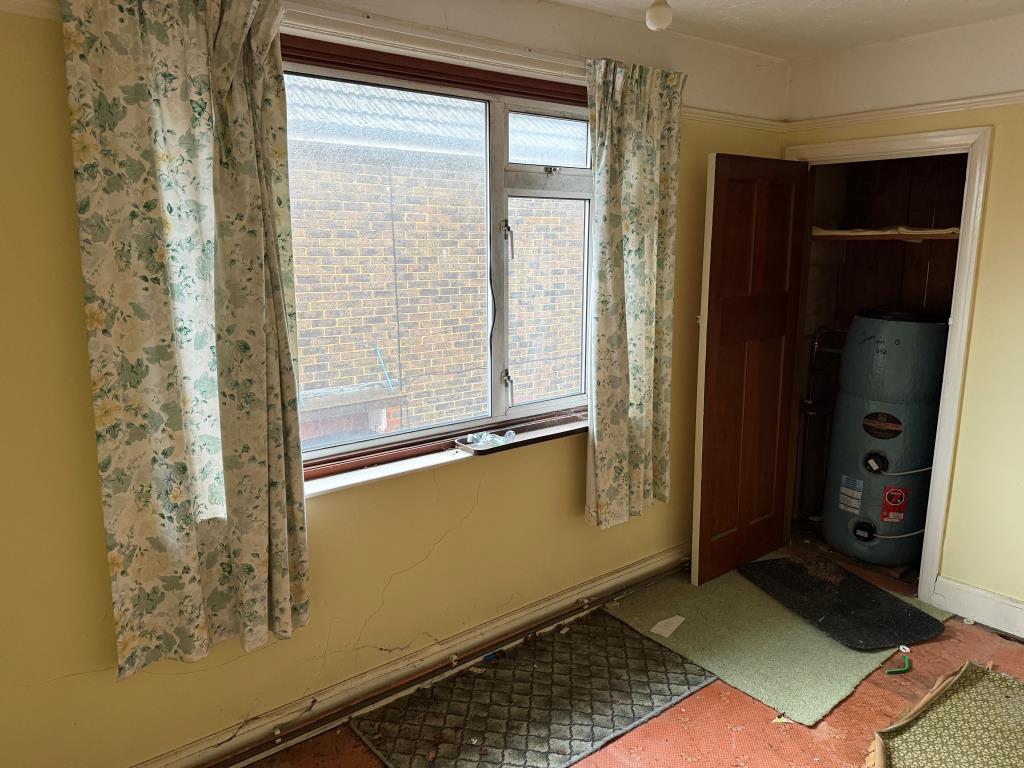 Lot: 44 - SEMI-DETACHED HOUSE IN NEED OF MODERNISATION - Main bedroom with view over side access